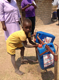 Child using a Tippy Tap, a low-cost device to promote handwashing
