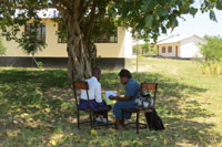 Study nurse interviewing study participant outside a school in Mwanza, Tanzania